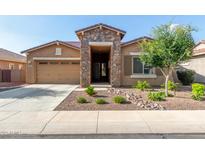 Charming single-story home featuring a stone facade, desert landscaping, and a two car garage at 3894 E Dogwood Pl, Chandler, AZ 85286