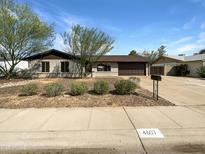 Charming single-story home with desert landscaping, a brown roof, and a spacious driveway at 4607 W Becker Ln, Glendale, AZ 85304