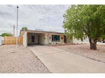Charming single-story home featuring a covered carport and a well-maintained gravel front yard at 5410 E University Dr, Mesa, AZ 85205