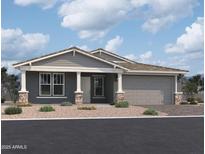 Charming single-story home features a two-car garage, stone accents, and a welcoming front entrance at 5610 W Hopi Trl, Laveen, AZ 85339