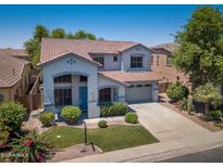 Beautiful two-story home featuring a tile roof, manicured lawn, and an attached two-car garage at 567 E Tropical Dr, Casa Grande, AZ 85122