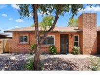 Charming single-story brick home with a well-maintained front yard and a mature tree at 6416 S Kenneth Pl # D, Tempe, AZ 85283