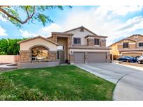 Stunning two-story home featuring stone accents, a three-car garage, and well-maintained landscaping at 7029 E Monte Cir, Mesa, AZ 85209