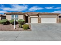 Charming single-story home featuring a three-car garage and well-manicured landscaping at 9952 W Jessie Ln, Peoria, AZ 85383