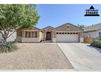 Home exterior showcasing a low-maintenance desert landscape, two-car garage, and stylish curb appeal at 1026 E Julie Ave, San Tan Valley, AZ 85140