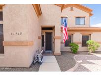 Inviting front entrance with security door, decorative stone, and neat, low-maintenance landscaping at 11419 E Ellis St, Mesa, AZ 85207
