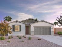 Charming single-story home with a two-car garage, desert landscaping, and a covered entryway at 12629 W Luxton Ln, Avondale, AZ 85323