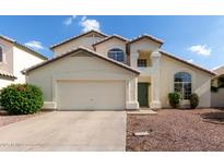 Charming two-story home with a two-car garage, well-maintained landscaping, and inviting curb appeal at 1421 E Charleston Ave, Phoenix, AZ 85022