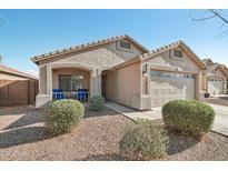 Charming single-story home with a well-maintained front yard and a cozy front porch with seating at 15453 W Shangri La Rd, Surprise, AZ 85379