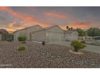 Charming single-story home with a well-manicured, low-maintenance rock front yard and a two-car garage at 15470 W Mauna Loa Ln, Surprise, AZ 85379
