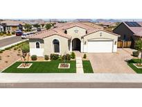 Charming single-story home featuring a tile roof, green lawn, and inviting front entrance with decorative shrubbery at 22721 N 34Th St, Phoenix, AZ 85050
