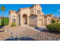Charming two-story stucco home featuring a well-manicured desert landscape, tile roof, arched entry, and a two-car garage at 24433 N 75Th St, Scottsdale, AZ 85255
