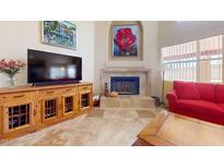 Cozy living room features a stone fireplace and unique cabinet, enhancing the room's charm at 2845 E Calavar Rd, Phoenix, AZ 85032