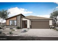 A charming single-story home featuring a two-car garage, stone accents, and desert landscaping at 28909 N 172Nd Dr, Surprise, AZ 85387
