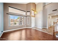 Spacious living room with high ceilings, hardwood floors, and an abundance of natural light at 3905 S Bridal Vail Dr, Gilbert, AZ 85297