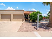 Charming single-story home featuring a two-car garage, landscaped front yard, and covered entry at 4501 E Carol Ave # 77, Mesa, AZ 85206
