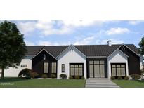 Charming new construction featuring modern farmhouse architecture, a metal roof, and manicured landscaping at 6234 S Brett Ct, Gilbert, AZ 85298