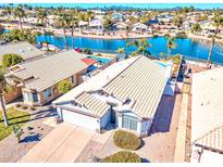 Beautiful waterfront property with a private pool and well-manicured landscaping at 7140 E Juanita Ave, Mesa, AZ 85209