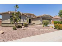 Single-story home boasting a desert landscape, attached garage, and neutral-toned exterior at 794 W Leatherwood Ave, Queen Creek, AZ 85140