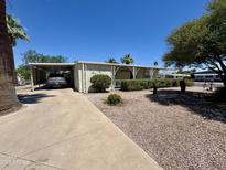 Single story home with covered parking, landscaped yard, and desert rock at 120 N Val Vista Dr # 272, Mesa, AZ 85213