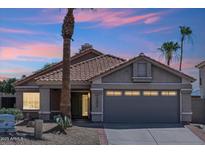 Charming single-story home featuring a tile roof, desert landscaping, and a spacious two-car garage at 1228 E Mountain Vista Dr, Phoenix, AZ 85048