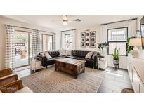 Bright living room featuring a leather couch, wooden chest, and stylish decor at 128 E Bluejay Dr, Chandler, AZ 85286