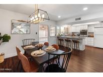 Stylish dining room features a modern light fixture and a mirror at 1525 E Southern Ave, Tempe, AZ 85282