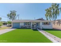 Charming single-story home with manicured lawn, blue shutters, and inviting entrance at 1749 E Medlock Dr, Phoenix, AZ 85016