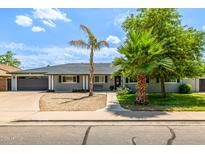 Beautiful single-story home with mature landscaping and a two-car garage at 253 N Fraser Dr, Mesa, AZ 85203