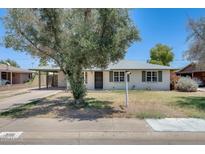 Charming single-story home with a well-manicured front yard and a covered carport at 3001 N 21St Ave, Phoenix, AZ 85015