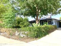 Charming home with lush green landscaping, mature trees, and a well-maintained front yard at 4629 N 9Th St, Phoenix, AZ 85014
