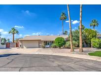 Charming single-story home with a well-maintained front yard, mature trees, and a two-car garage in a desirable neighborhood at 5119 N 87Th St, Scottsdale, AZ 85250