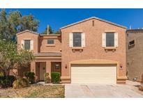 Inviting two-story home featuring a two-car garage and a cozy front porch, enhanced by desert landscaping at 7029 S Golfside Ln, Phoenix, AZ 85042