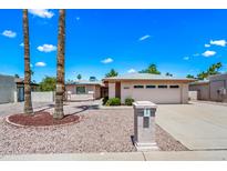 Charming single-story home with a well-maintained landscape and attached garage, showcasing its inviting curb appeal at 9654 E Foster Ave, Sun Lakes, AZ 85248