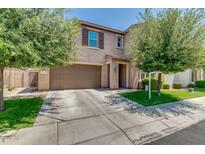 Charming two-story home featuring a two-car garage, well-maintained lawn, and mature trees at 974 W Zion Way, Chandler, AZ 85248