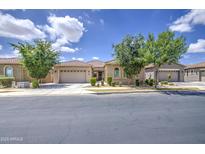 Charming single-story home featuring a tile roof, landscaped front yard, and two-car garage at 9845 E Thistle Ave, Mesa, AZ 85212