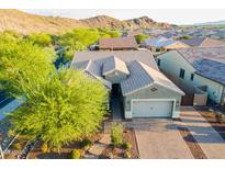 Beautiful desert home with a tile roof, paved driveway and lush landscaping at 10207 W Hedge Hog Pl, Peoria, AZ 85383