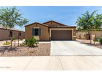 Charming single-story home featuring a desert-landscaped front yard and a two-car garage at 128 S 200Th Ave, Buckeye, AZ 85326