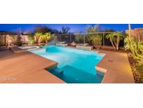 Inviting pool with water features and seating area, perfect for relaxation and entertaining at 13719 W Amberwing St, Peoria, AZ 85383