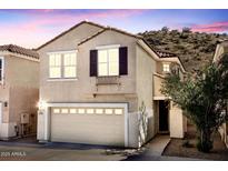 Charming two-story home featuring a tile roof and attached two-car garage at 215 W Mountain Sage Dr, Phoenix, AZ 85045