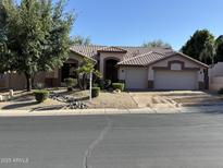Charming single-story home with well-manicured landscaping and a two-car garage at 22364 N 59Th Ln, Glendale, AZ 85310