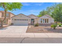 Charming single-story home with a two car garage, desert landscaping, and a covered entryway for curb appeal at 2620 E Rustling Oaks Ln, Phoenix, AZ 85024
