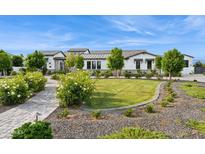 Stunning front yard of home featuring manicured lawn, stone walkway and lush landscaping at 4024 E Minton Cir, Mesa, AZ 85215