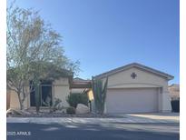 Charming single-story home featuring desert landscaping and a neutral color palette in a peaceful residential neighborhood at 41603 N Cedar Chase Rd, Anthem, AZ 85086