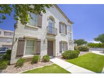 Charming two-story home featuring a stucco facade, decorative shutters, and a small wrought-iron balcony at 5749 S 21St Ter, Phoenix, AZ 85040
