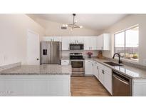 Modern kitchen features stainless steel appliances and granite countertops at 8103 E Dartmouth St, Mesa, AZ 85207