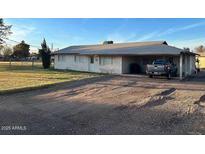 Charming single-story home with covered parking and well-maintained lawn at 834 E Lockwood St, Mesa, AZ 85203