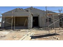 Exterior elevation of a home under construction, with scaffolding and raw materials visible, offering a glimpse of the building process at 9531 W Parkway Dr, Tolleson, AZ 85353