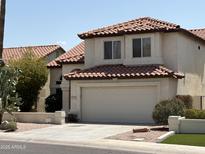 Charming two-story home with a tile roof, manicured landscaping, and a two-car garage at 9649 S 51 St St, Phoenix, AZ 85044