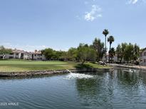 Beautiful view of a lake and golf course showcasing community living with greenery and water features at 9649 S 51 St St, Phoenix, AZ 85044